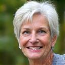 Portrait of Emma R., a smiling woman over 45, radiating vitality.